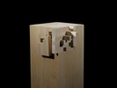 Photograph of bass wood cube model on base with shifted portions of the cube.