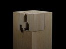 Photograph of bass wood cube model on basewith shifted portions of the cube.