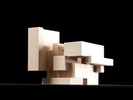 Photograph of bass wood cube model with shifted portions of the cube.