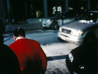 Photo of a man crossing the street.