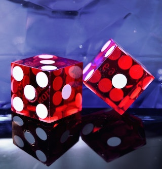 Two red dice on a surface.