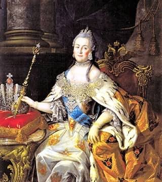 A serene-looking, grey-haired woman, adorned in a colorful, low-bodiced robe, sits on a throne, with a scepter in her hand.