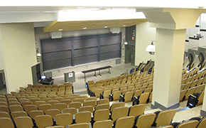 A large lecture hall, looking down toward the lectern and blackboards.