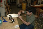 Fine shaping with a cabinet scraper.  Other key tools: chisel (foreground), spokeshave (left), and medium plane (right).