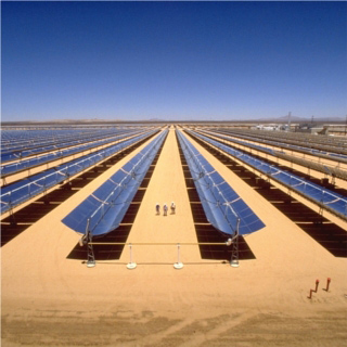 Three people walk between huge mirrored troughs, pointed straight upwards, extending for thousands of feet beyond in all directions.