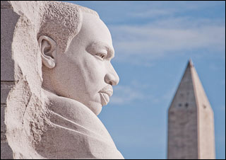 A sideview of a man's head, chiseled from stone.