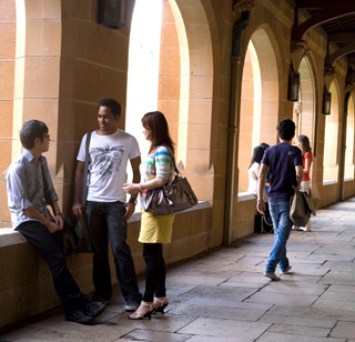 Four students having a discussion in a hallway.