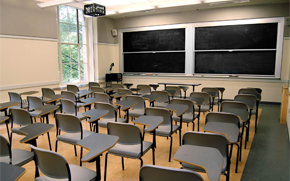 Flat classroom with movable chairs and tables. Audiovisual requirements include a projector and speakers as some video is shown.