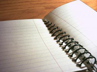 An open, spiral-bound notebook.