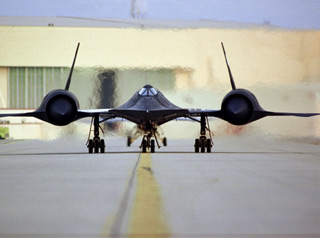 A stealth jet speeding down the runway.