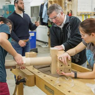 A group of students and a professor working on a project