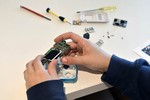 A photo of a person's hands holding a Raspberry Pi computer.